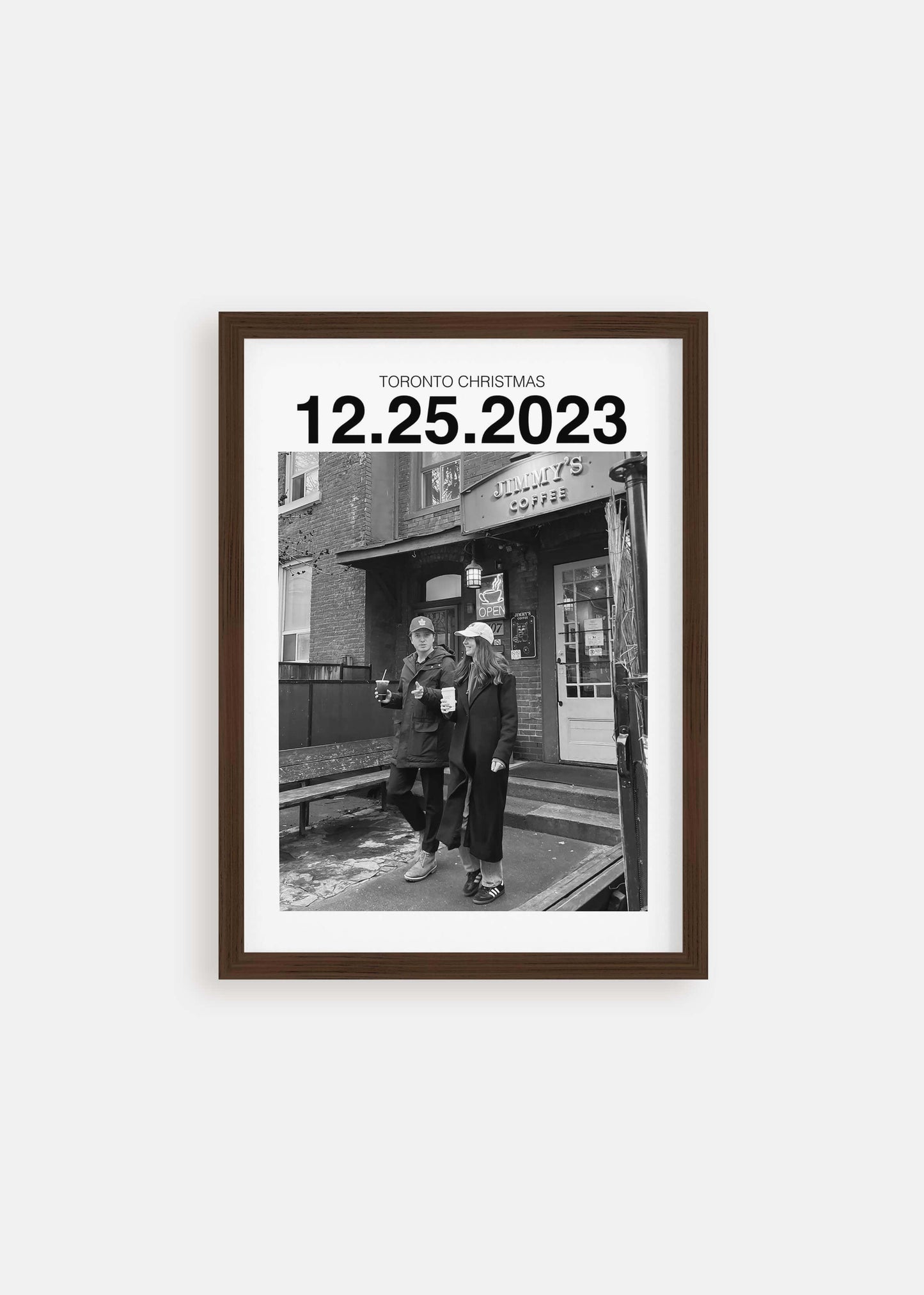 Personalized black and white photo gift with custom date in walnut frame on white background.
