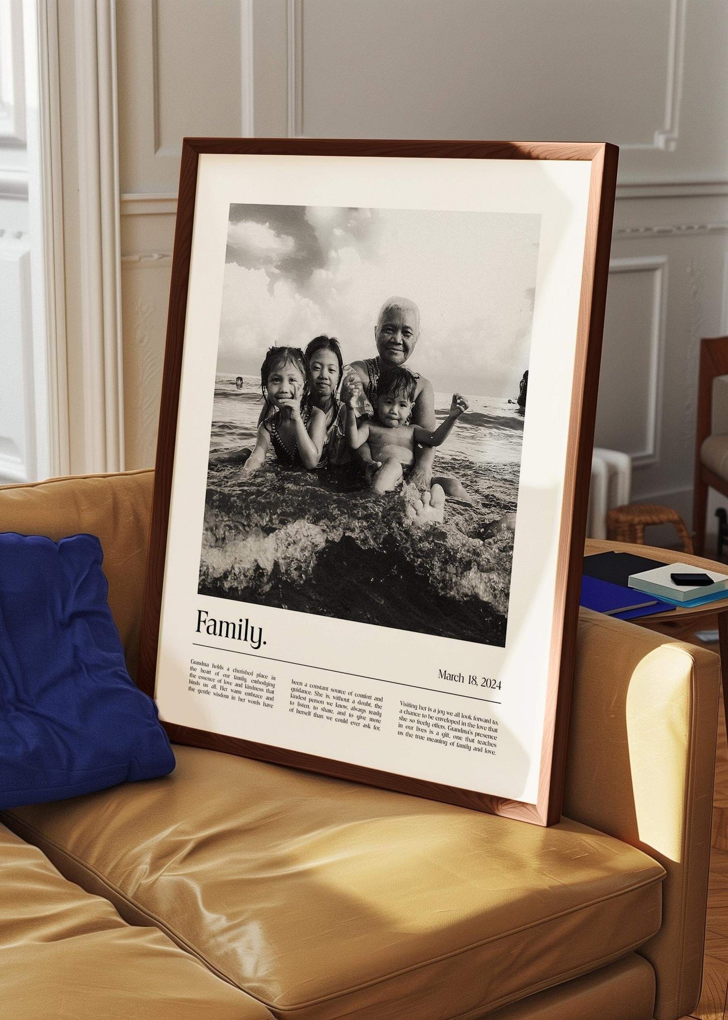Personalized black and white photo gift of children with grandma and a custom message added. Large Walnut picture frame leaning on sofa.