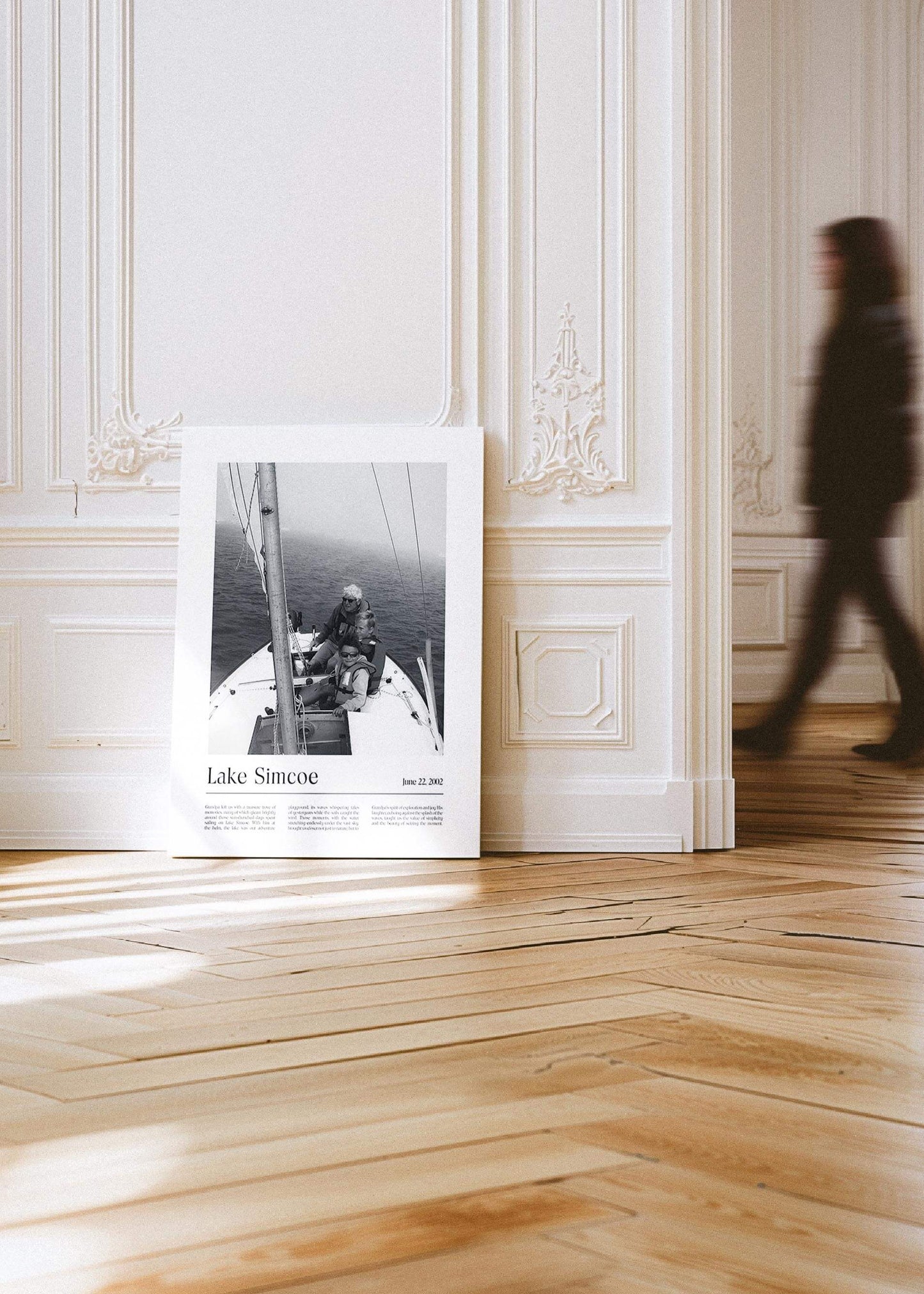 Personalized black and white photo gift on canvas of children with grandpa sailing. The canvas is leaning against a wall in a contemporary gallery setting and has a custom message inscribed on it.
