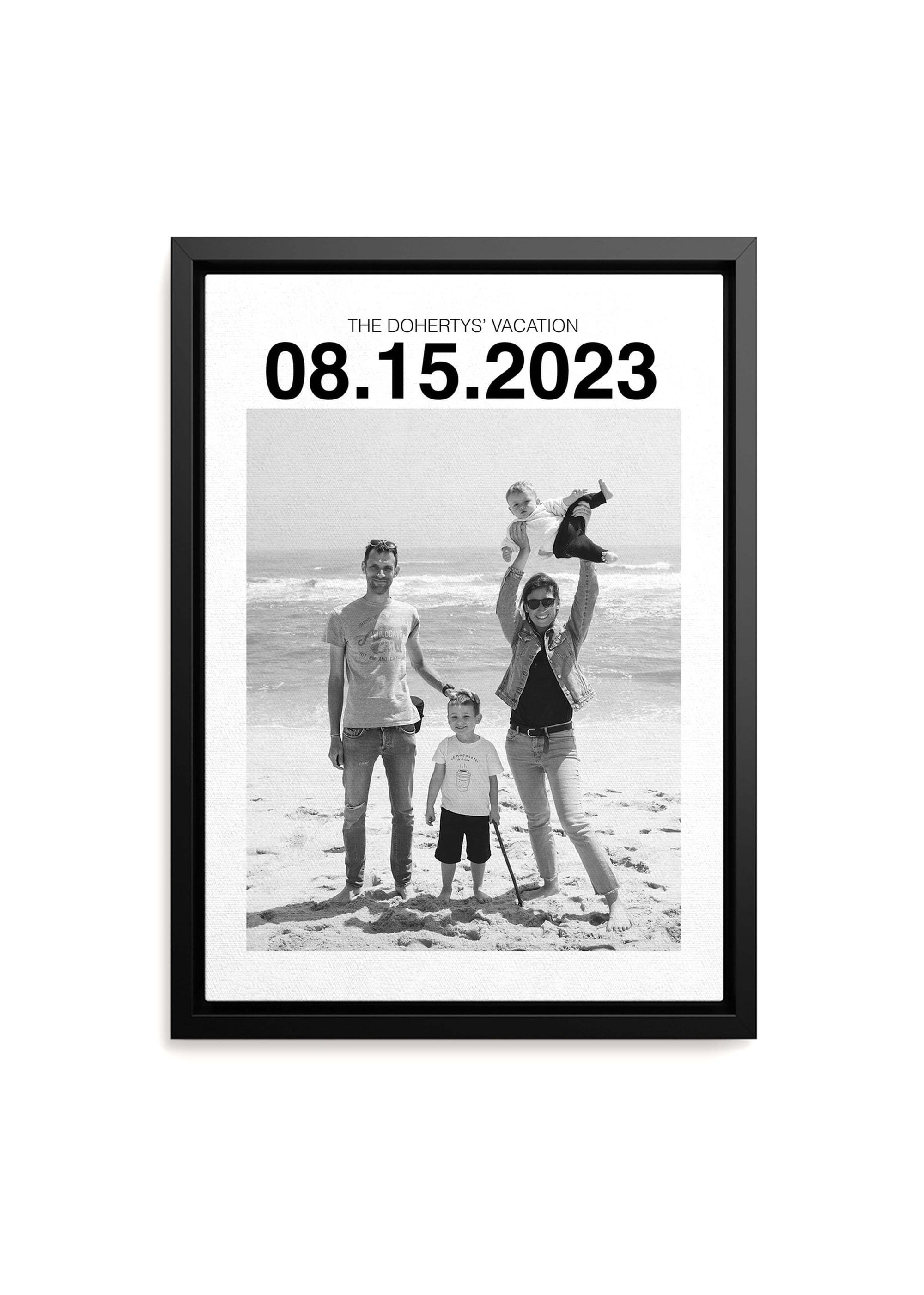 custom personalized black and white photo of a family on holiday. The black framed canvas has a large custom date at the top and the canvas sits on a white background.
