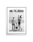 custom personalized black and white photo of a family on holiday. The white framed canvas has a large custom date at the top and the canvas sits on a white background.
