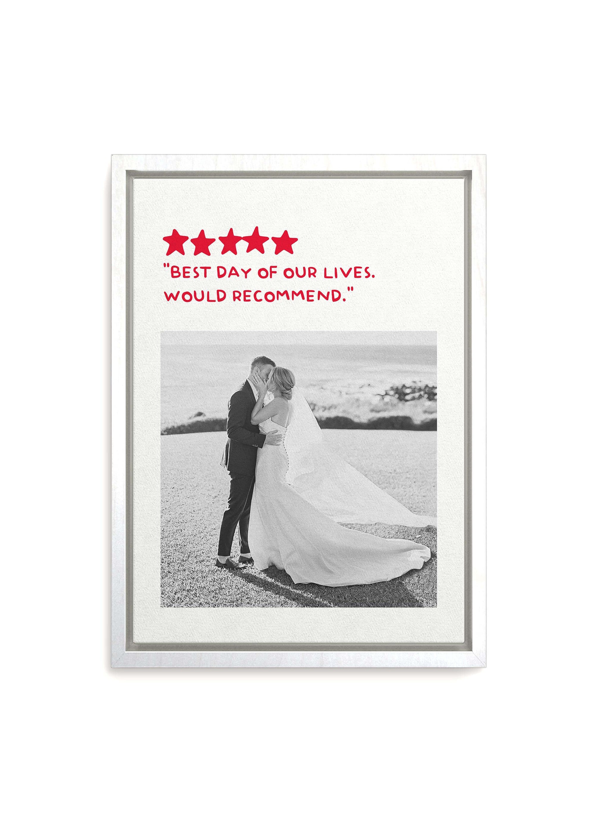 Personalized anniversary gift with photo of couple on their wedding day turned into black and white on white framed canvas with a custom humorous review added. Canvas is on white background.