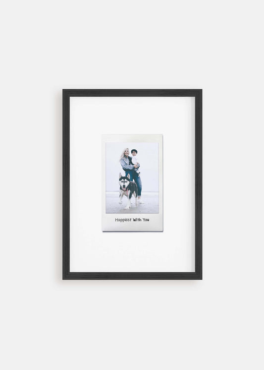 Personalized photo gift of a woman with her child and dog in a black frame in the style of a nostalgic instant film custom polaroid photo with frame on white background.