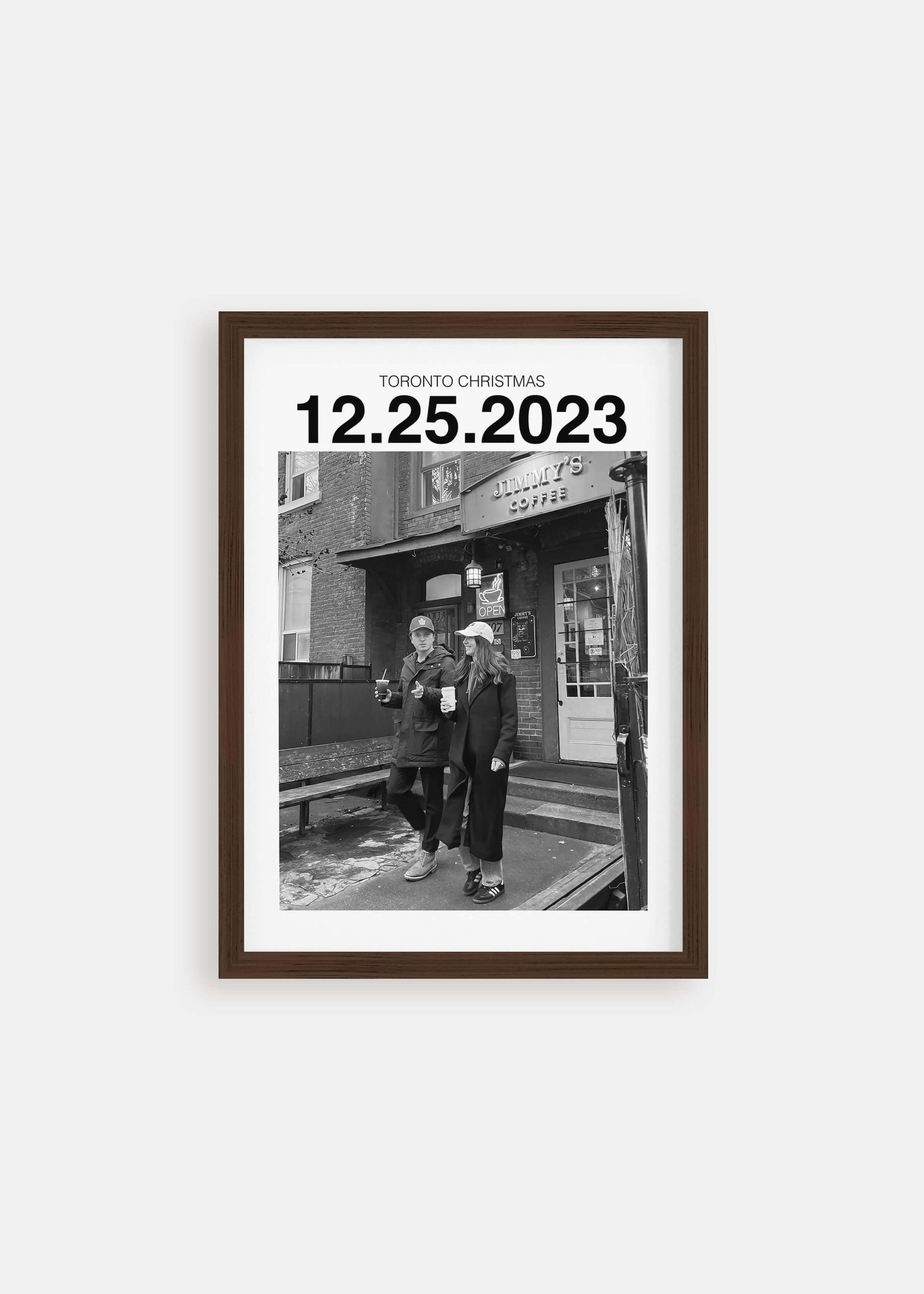 Personalized black and white photo gift with custom date in walnut frame on white background.