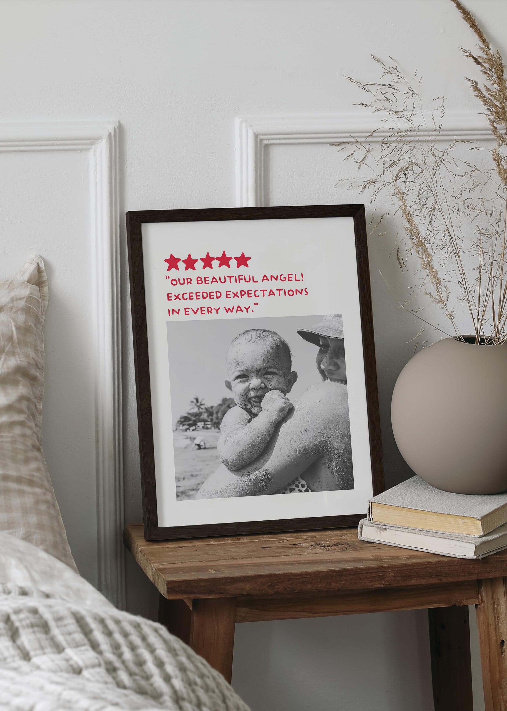 Personalized black and white photo gift in black frame on small bed side table. The photo gift is a humorous custom review style design.