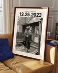 Personalized black and white photo gift with custom date in black frame leaning on sofa.